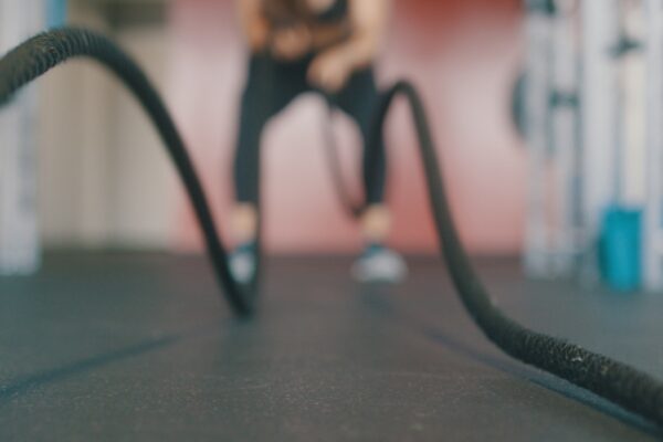 person holding black exercise rope
